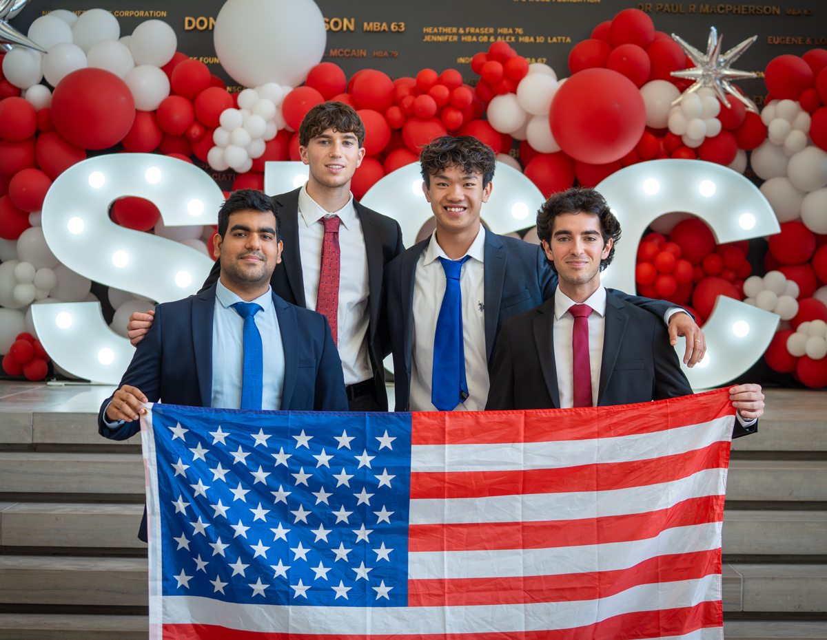 Business Case Competition team posing with a U.S. flag.
