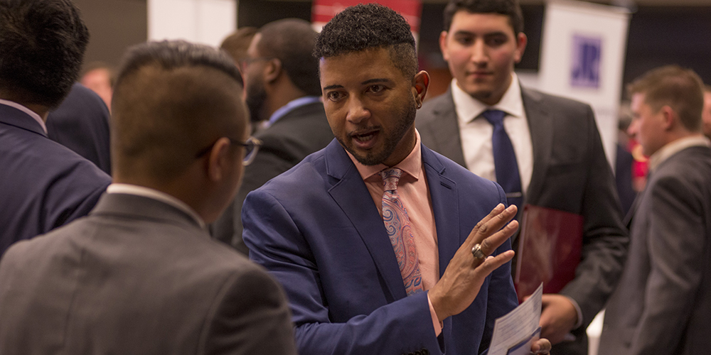 Finance students talking at an event